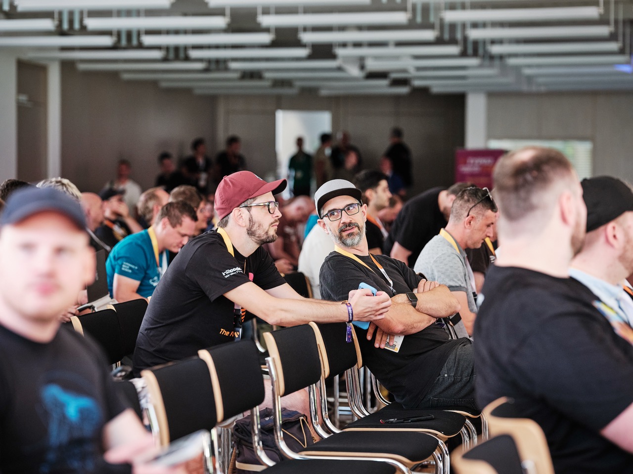 Audience seated in rows listening to a talk at an event.